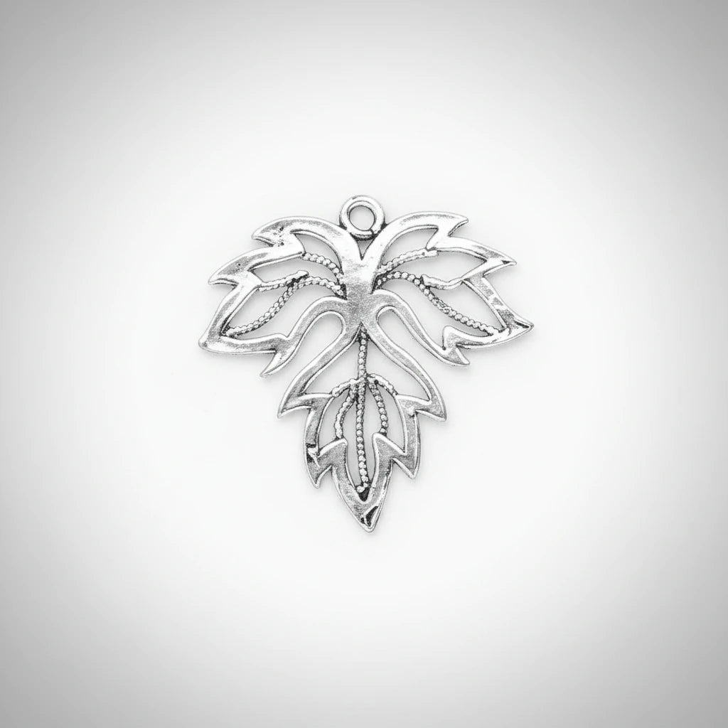 A silver-toned metal leaf-shaped charm with an openwork design and a small loop at the top, shown on a solid dark gray background.