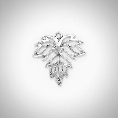 A silver-toned metal leaf-shaped charm with an openwork design and a small loop at the top, shown on a solid dark gray background.