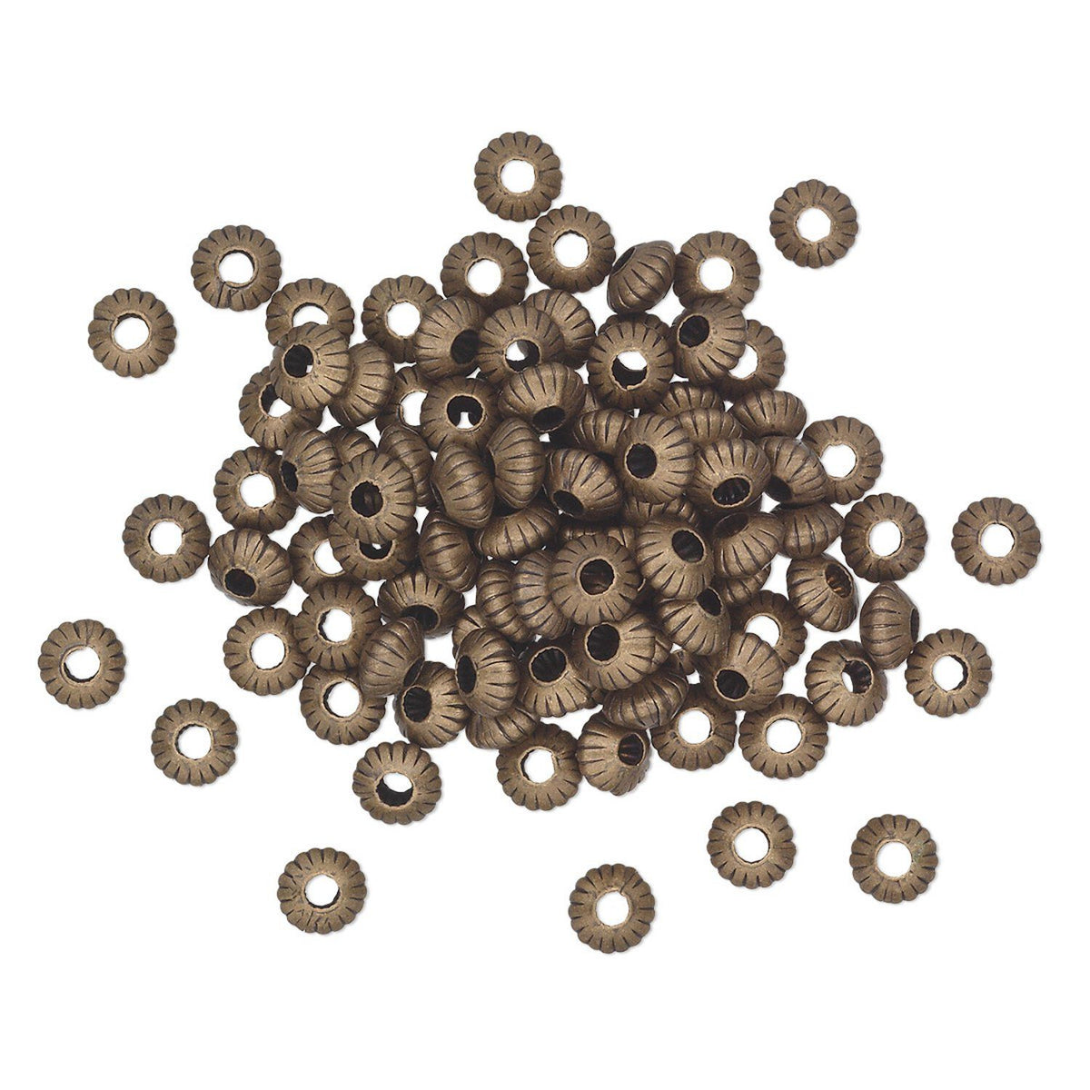 A pile of small metallic spacer beads with a textured, ribbed outer edge and a central hole, shown on a plain white background.