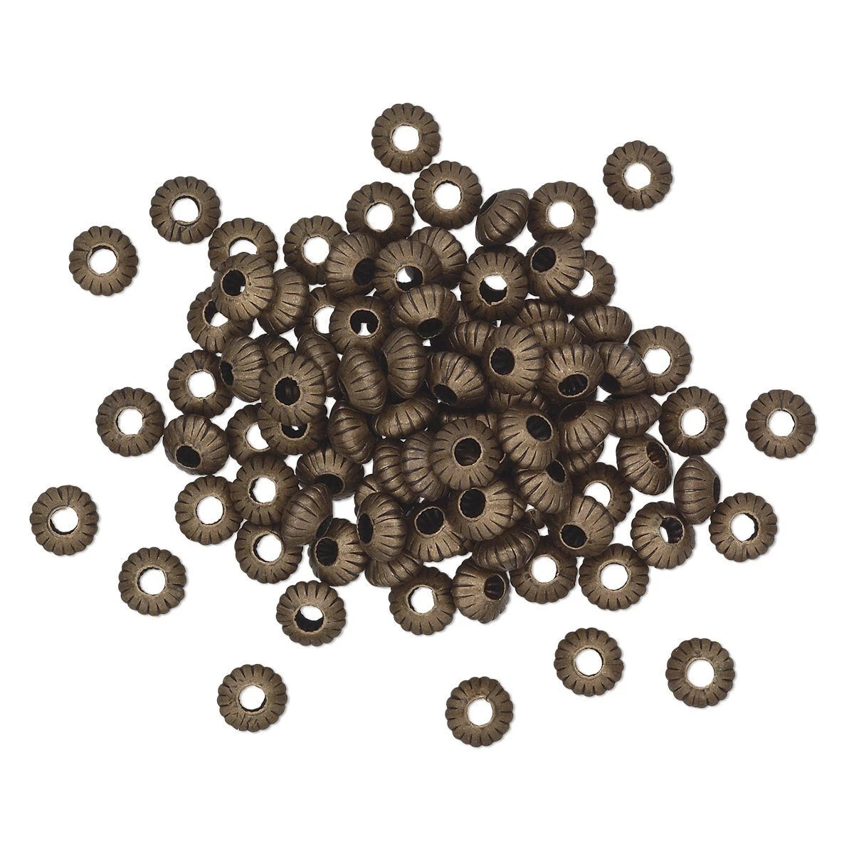 A pile of small metallic spacer beads with a textured, ribbed outer ring and a central hole, shown on a plain white background.