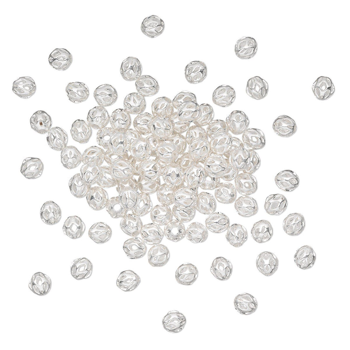 A pile of faceted silver beads scattered on a plain white background.