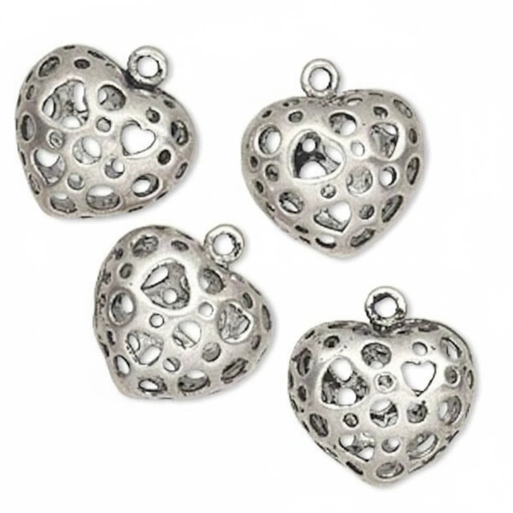 Four silver heart-shaped jewelry charms with intricate cutout patterns and small loops at the top, displayed on a clean white background.
