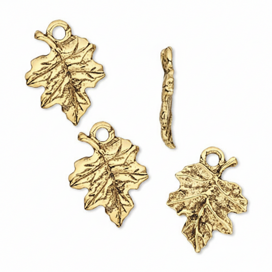 Four gold-toned leaf-shaped charms with textured details, including two larger oak leaves, one smaller oak leaf, and one twig-shaped charm, displayed on a clean white background.