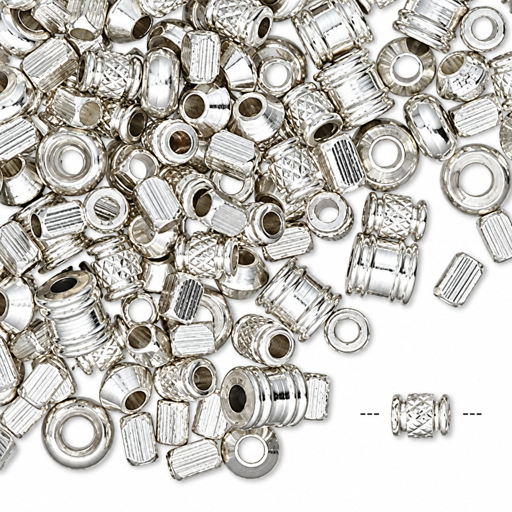 A pile of small silver-toned metal spacers or connector pieces on a white background, with a single piece shown separately at the bottom right.