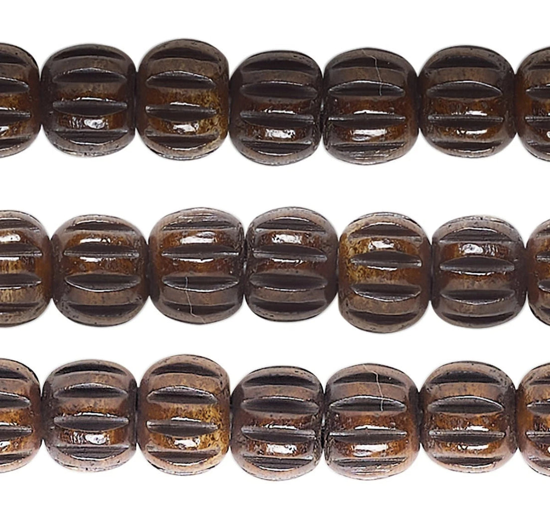 Three horizontal strands of glossy, dark brown carved wooden beads with a ribbed, textured surface, shown against a plain white background.