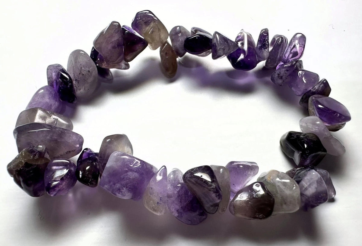 A tumbled amethyst stone bracelet arranged in a circle on a plain white background.