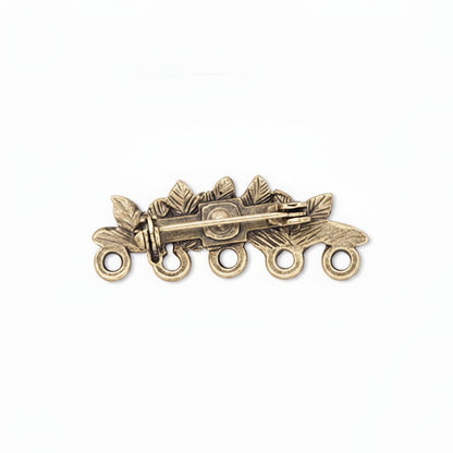 An antique bronze-toned metal brooch shown from three angles: front view with leaf and berry motifs and five hanging loops, side view showing the pin clasp mechanism, and back view with the pin stem and clasp visible.