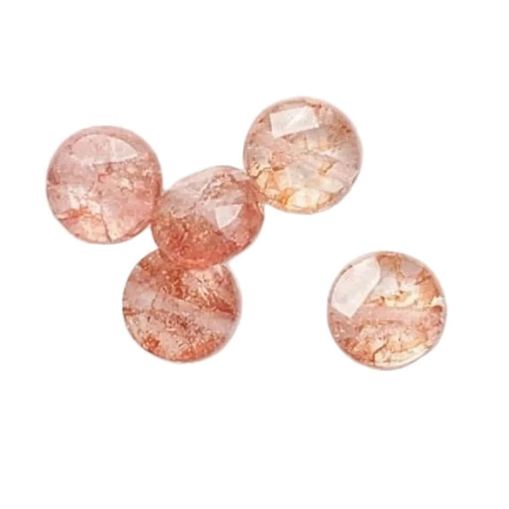 Four round faceted gemstone beads in a peachy pink color with natural crystalline texture, displayed on a clean white background.