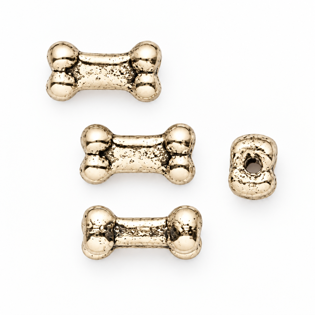 Four gold bone-shaped beads with a textured, metallic finish, displayed on a clean white background.