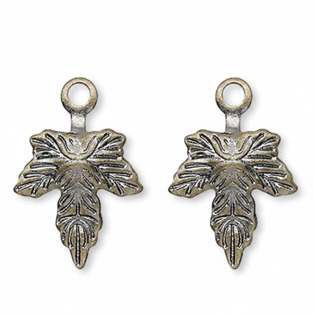 Three identical small metal charms with a leaf-like embossed design and a top loop, shown on a plain white background.