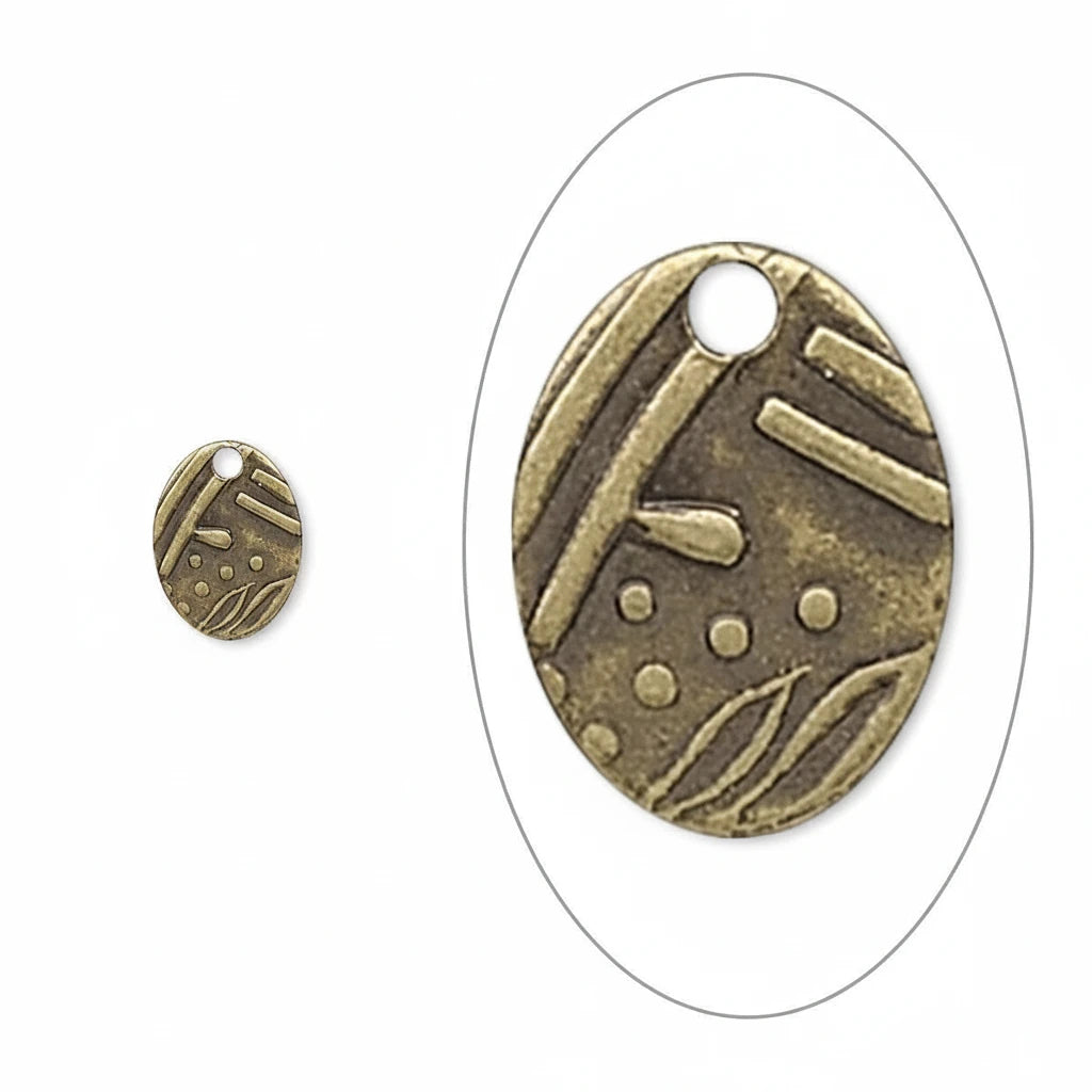 An oval antique bronze metal charm with a pre-drilled hole, featuring embossed abstract patterns, shown both as a full view and a close-up inset on a white background.