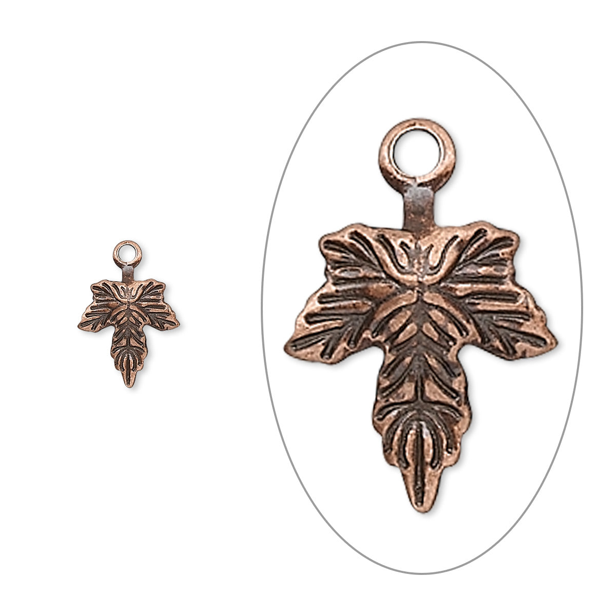 An antique bronze cross charm with an embossed floral design and a top loop, shown in a close-up inside a white oval on the right and a smaller full view on the left, against a plain white background.