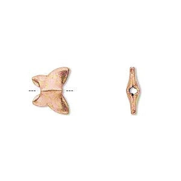 Two small copperjewelry findings on a plain white background, one butterfly-shaped and one diamond-shaped with a central hole.