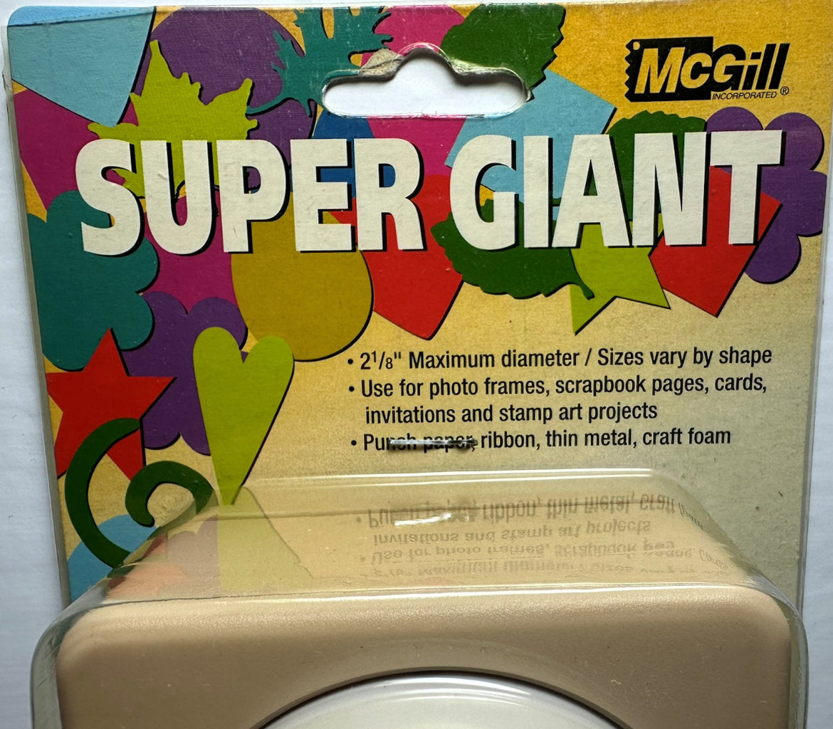 McGill Super Giant die-cut craft foam sheet in its original retail packaging, featuring a colorful background with green, yellow, purple, and red shapes, and a beige foam sheet visible at the bottom.