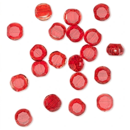 A scattered collection of faceted red glass beads on a plain white background.