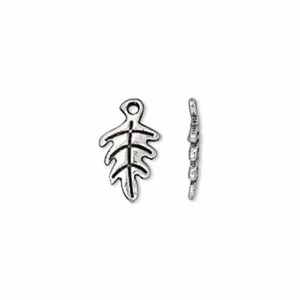 A pair of silver-toned metal leaf-shaped charms, one shown from the front and the other from the side profile, on a plain white background.
