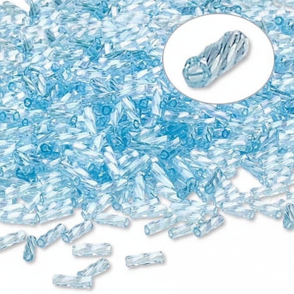Light blue faceted crystal beads scattered on a white background, with a circular inset showing a single twisted cylindrical bead detail.