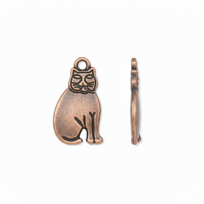An antique bronze metal charm shaped like a sitting cat, shown from both the front and side profiles on a clean white background.