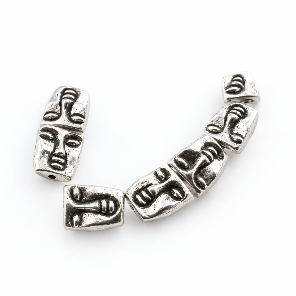 silver beads featuring detailed, stylized face carvings, shown on a white background with a watermark at the top.
