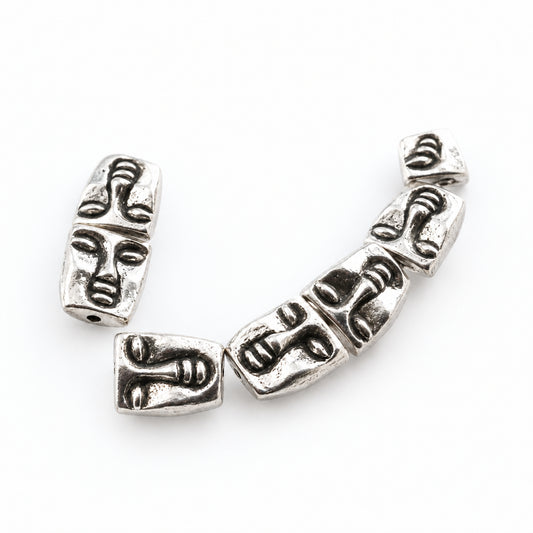 silver beads featuring detailed, stylized face carvings, shown on a white background with a watermark at the top.