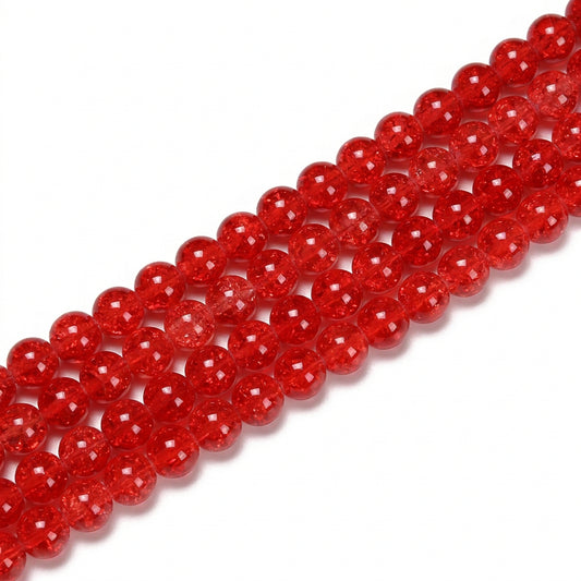 A close-up of a strand of glossy, translucent red round beads arranged diagonally on a plain white background.