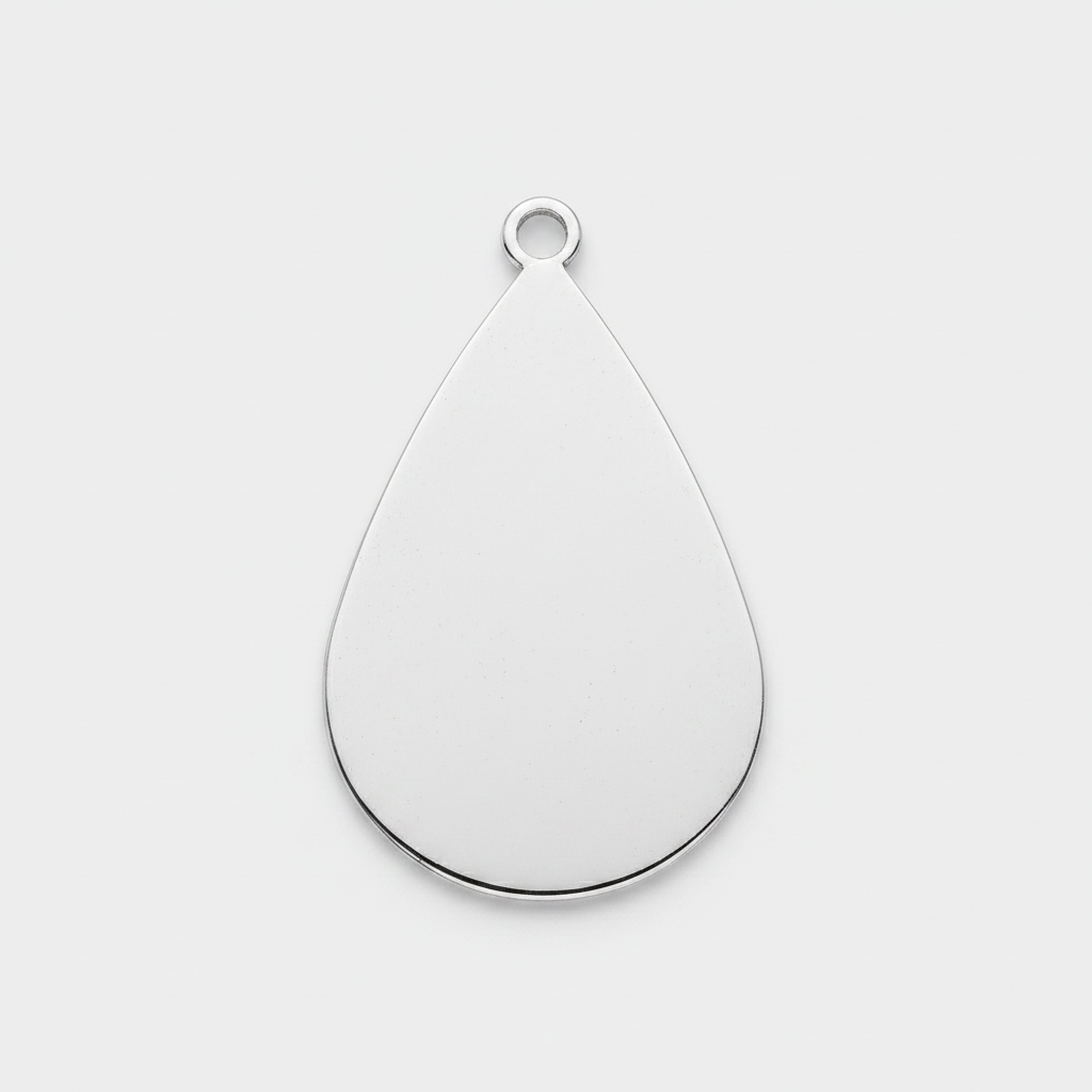 A teardrop-shaped silver metal pendant with a small loop at the top, shown on a plain white background.