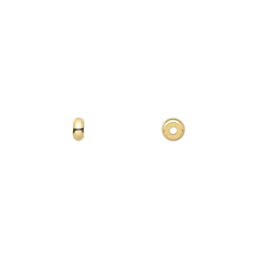 Two small gold beads on a plain white background: a tiny dome-shaped bead on the left and a flat circular disc with a center hole on the right.