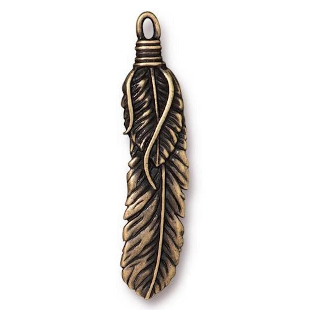 An antique bronze feather pendant charm with a detailed textured feather design and a wrapped loop at the top, shown on a plain white background.