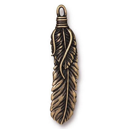 An antique bronze feather pendant charm with a detailed textured feather design and a wrapped loop at the top, shown on a plain white background.