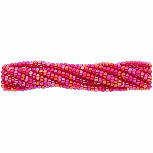 A close-up of a strand of faceted round beads in a vibrant magenta pink and orange gradient, laid horizontally on a plain white background.