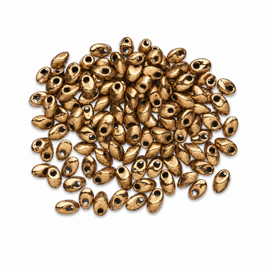 A pile of metallic bronze oval beads with central holes, arranged on a clean white background.