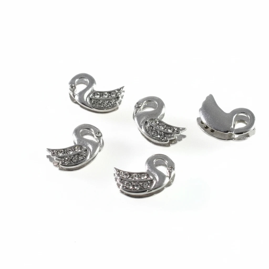 Five silver-toned swan-shaped jewelry findings or charms with small clear rhinestones, shown on a plain white background from both front and back views.