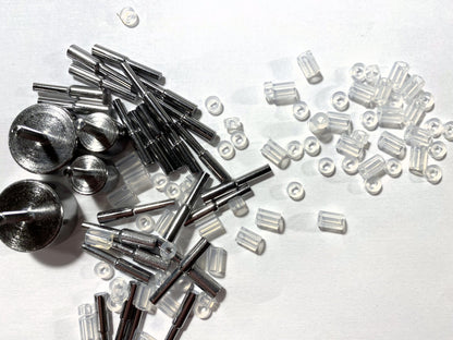 Collection of metal and clear plastic components on a white background