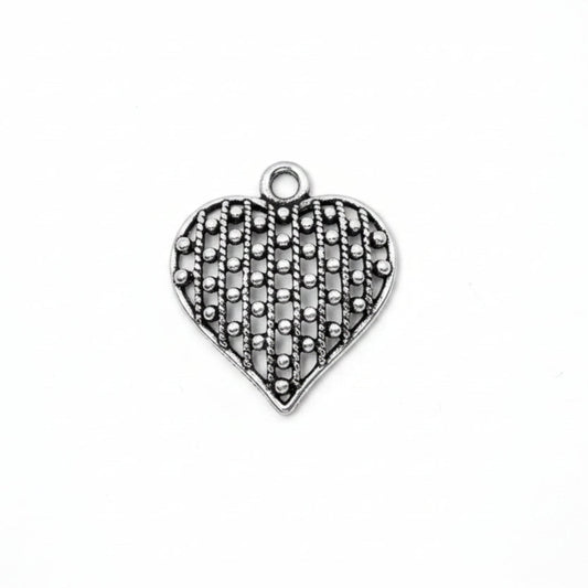 A heart-shaped silver charm with an openwork, textured pattern and a small top loop, shown on a plain white background.