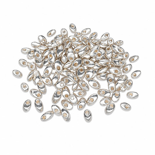 A pile of small metallic silver teardrop-shaped beads with pre-drilled holes, scattered on a plain white background.
