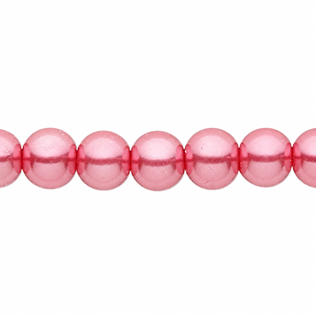 A close-up of glossy, pink round beads strung horizontally against a plain white background.