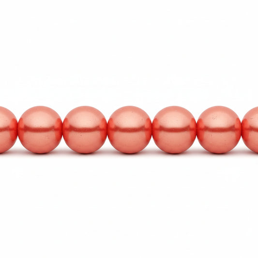 A close-up of glossy, metallic coral-pink round beads strung horizontally on a white background.