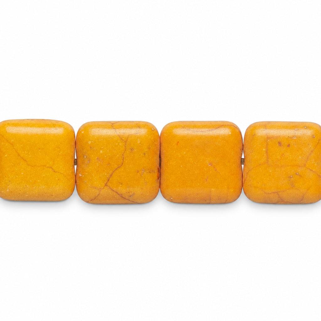 Four square yellow-orange stone beads with natural matrix veining, shown in a row on a plain white background.