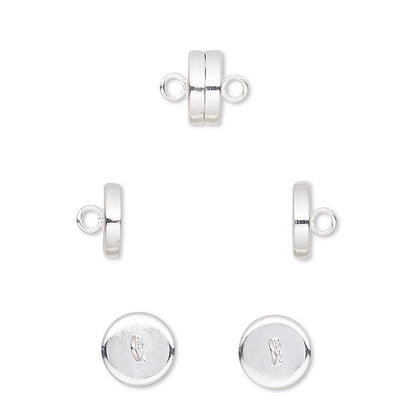 Sterling silver jewelry findings set including a double-loop clasp, a side tab clasp, and two round disc end caps with an engraved monogram logo, displayed on a clean white background.