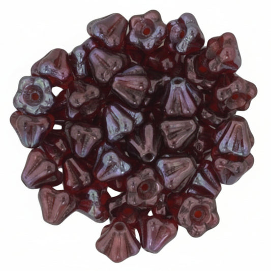 A pile of small, translucent dark red glass beads with a textured, ribbed surface and a central hole, shown on a plain white background.