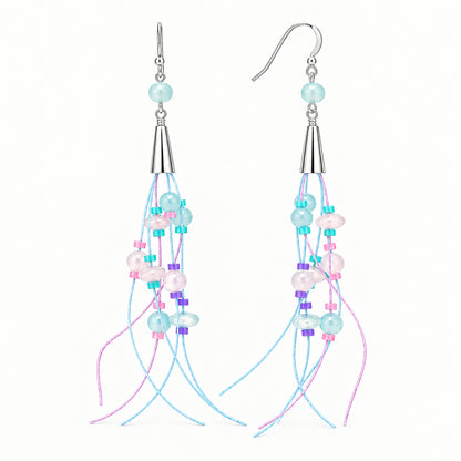 A pair of long dangle earrings with silver-toned metal hooks and cones, decorated with light blue, white, pink, and purple beads, shown against a solid dark gray background.