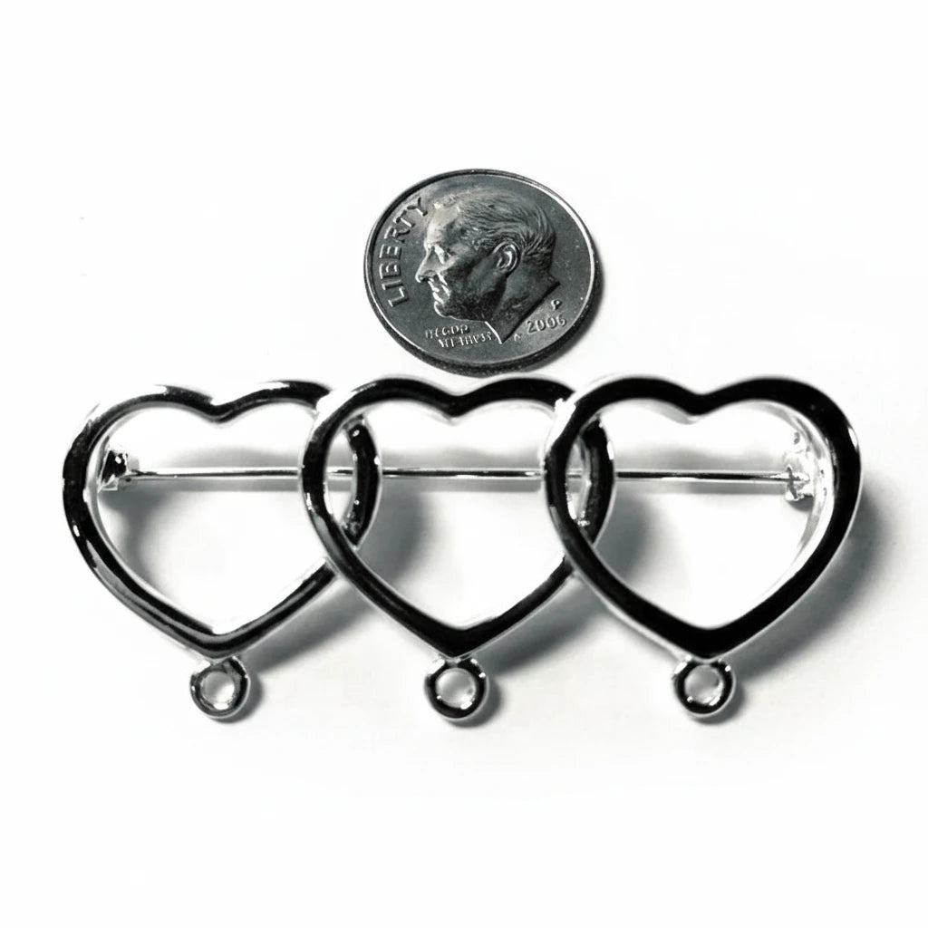 Three silver heart-shaped metal pin frames with loops at the bottom, arranged side by side on a white background with a U.S.