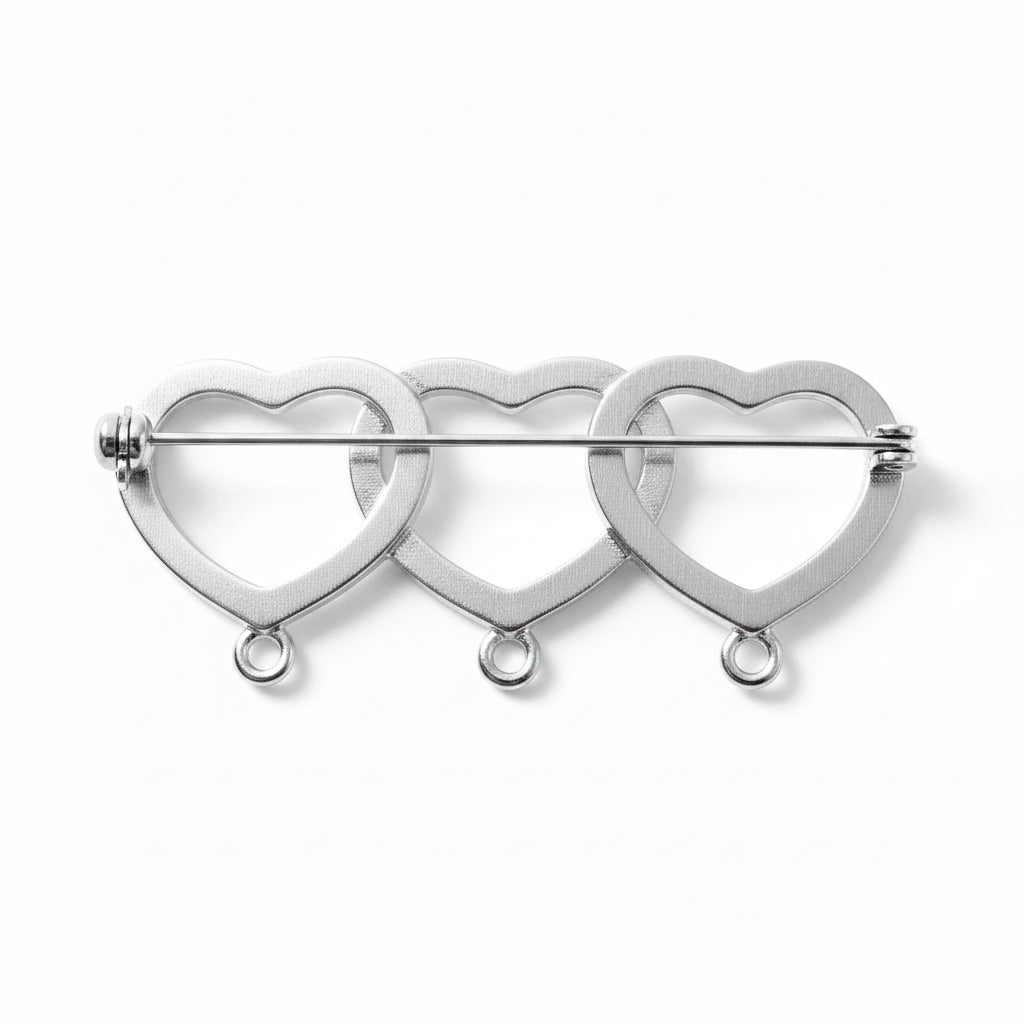 A silver-toned metal pin featuring three interlocking open heart shapes outlined with small sparkling rhinestone-like details, shown on a plain light background.