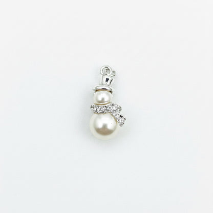 A small snowman pendant charm featuring two cream-colored faux pearls, a silver-tone top hat, and a silver bow with clear rhinestone accents, set against a plain light gray background.