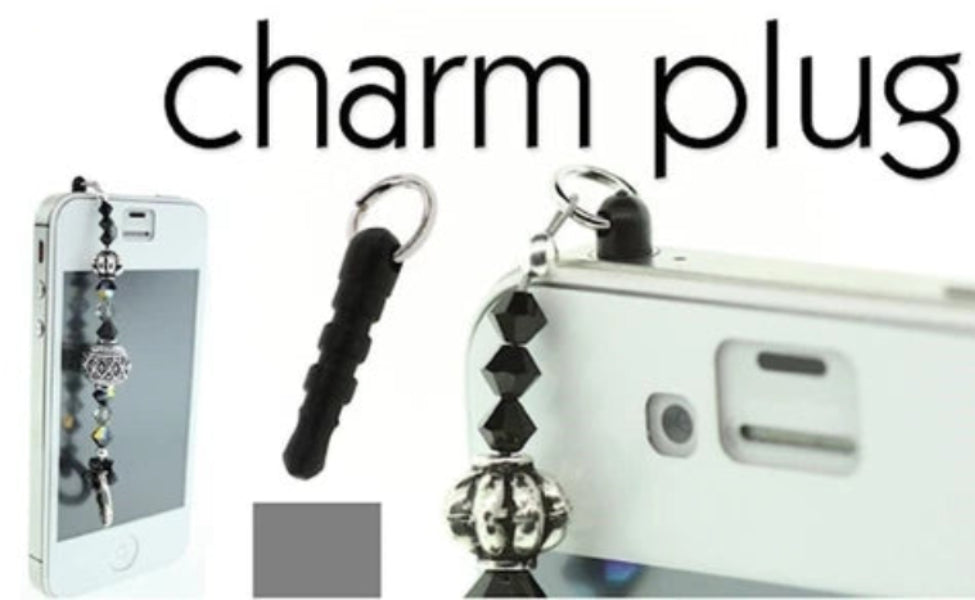 A phone charm plug accessory shown attached to a white phone, with a black textured loop and silver metal keychain ring. The image includes the text 'charm plug' at the top and a small gray square swatch near the bottom.