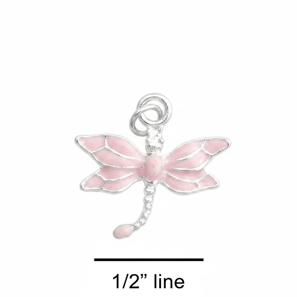 A small dragonfly charm with pink wings and a silver body and loop, shown on a blue textured background with a '1/2" line' size marker below.