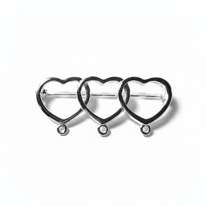 Three interlocking silver heart-shaped metal clasps or connectors arranged in a row on a light gray background.