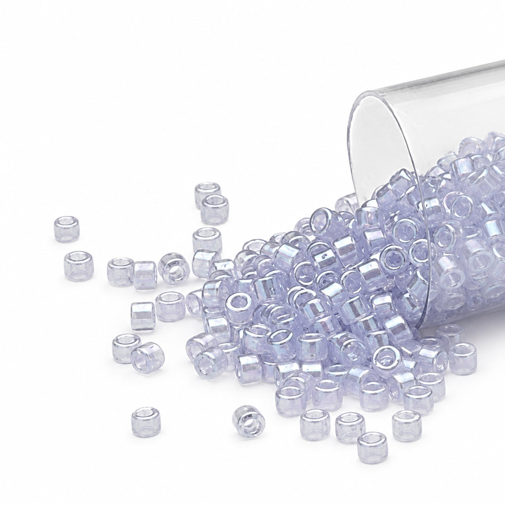 beads with a light lavender tint, spilling out of a clear cylindrical container on a white background.