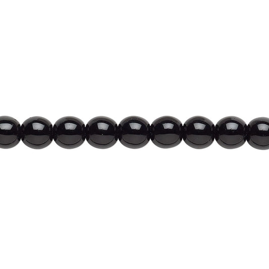A close-up horizontal line of glossy black round beads on a plain white background.
