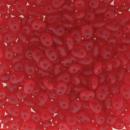 A close-up, top-down view of numerous small, translucent red seed beads with a double hole, filling the entire frame.